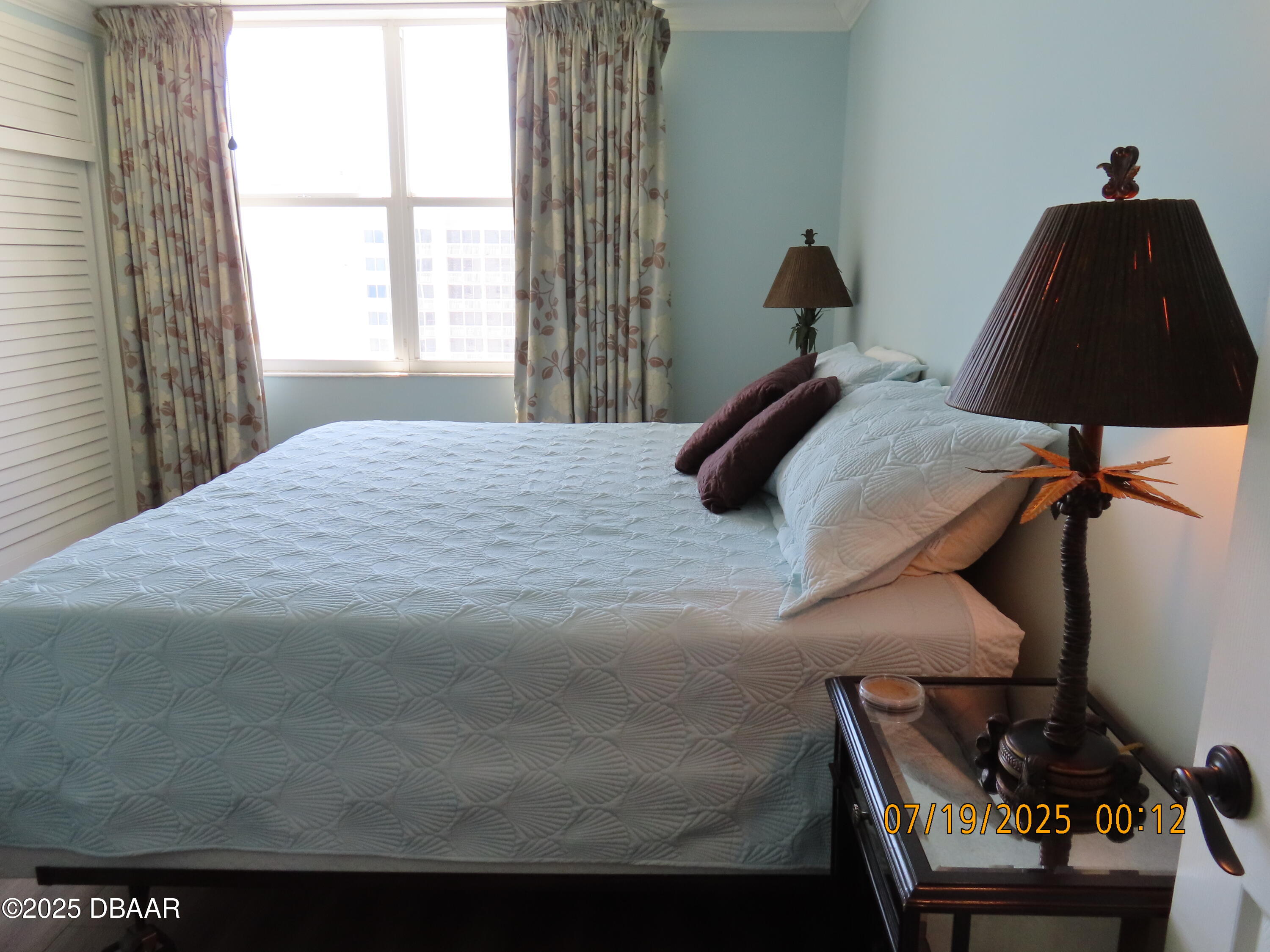 2800 North Atlantic Avenue, Unit 1206 Daytona Beach, FL 32118 - Photo 11 of 27 a bedroom with a bed and a window