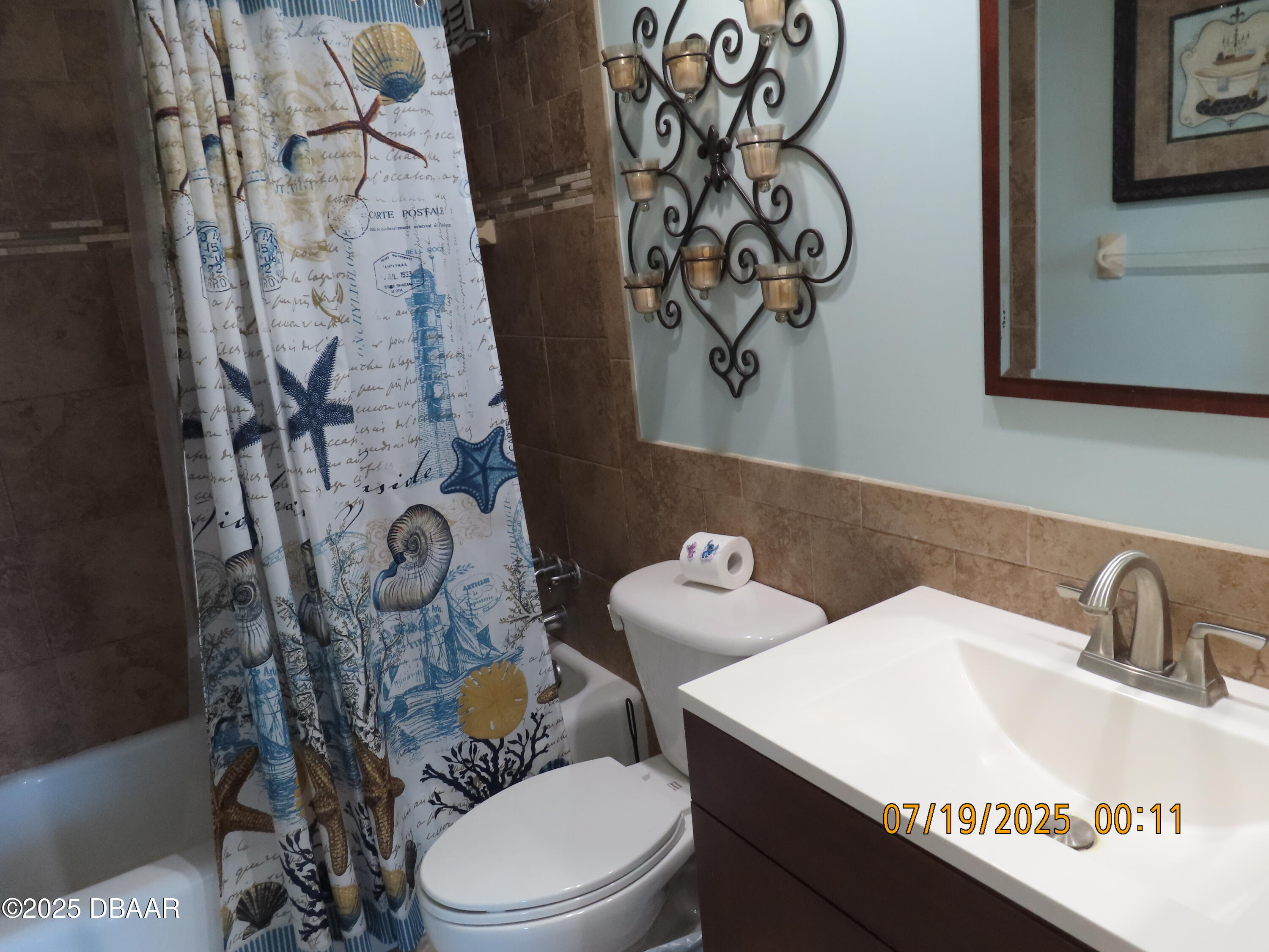 2800 North Atlantic Avenue, Unit 1206 Daytona Beach, FL 32118 - Photo 18 of 27 a bathroom with a toilet sink and mirror