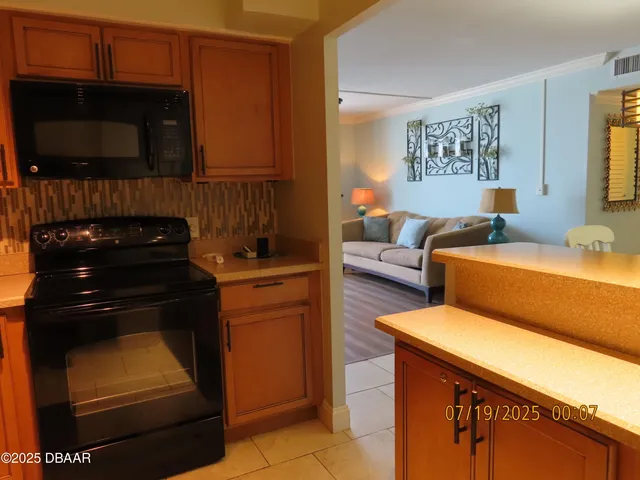 a kitchen with a refrigerator and a stove