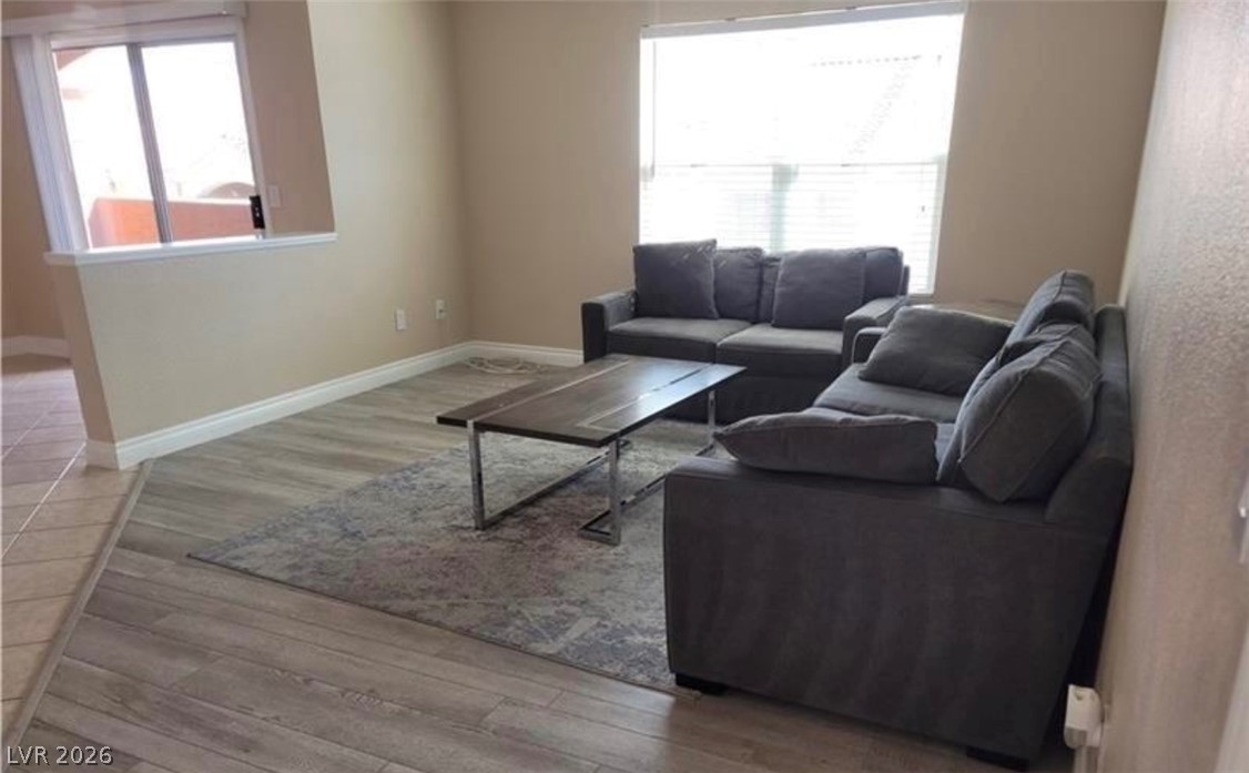 8101 West Flamingo Road, Unit 2040 Las Vegas, NV 89147 - Photo 1 of 4 Plentiful natural light streams across the durable wood-look flooring through multiple large windows.