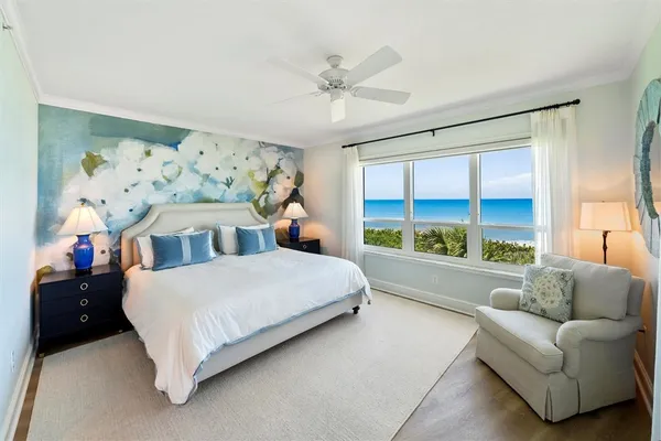 a spacious bedroom with a bed and a large window