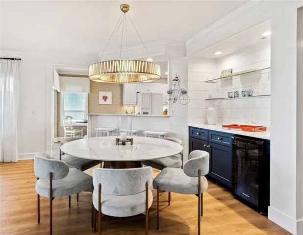 a view of a dining room with furniture and chandelier