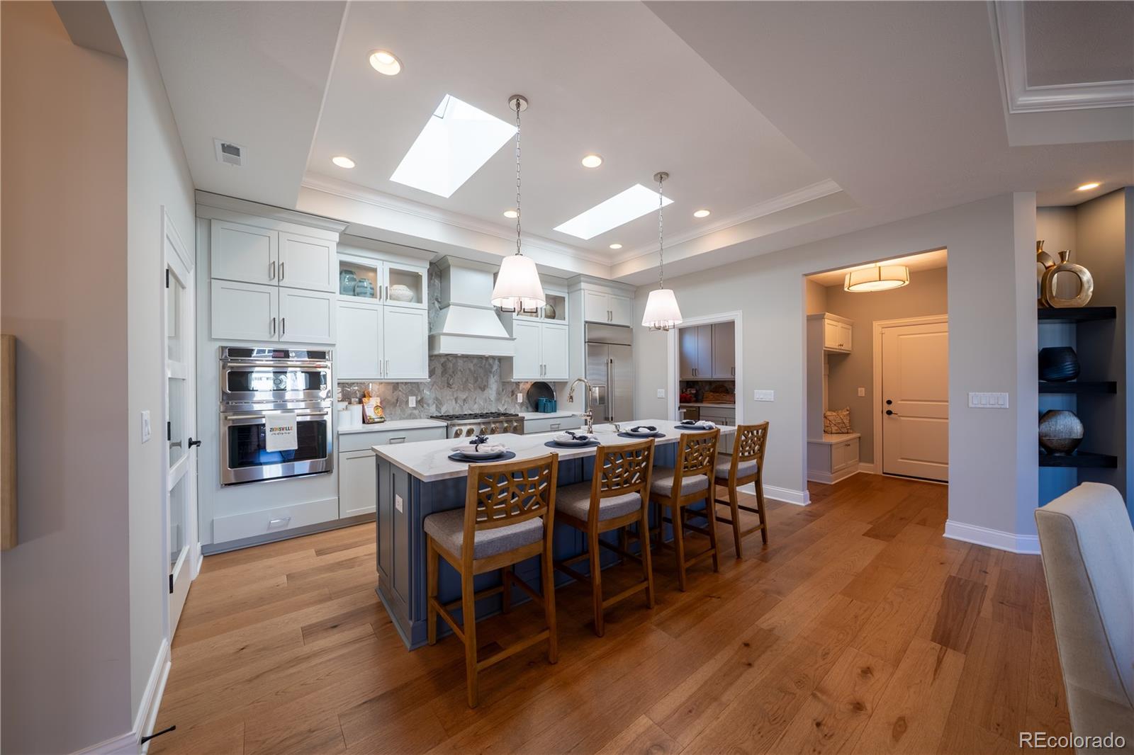 367 Josef Circle Fort Lupton, CO 80621 - Photo 15 of 36 a large kitchen with lots of counter space and dining table