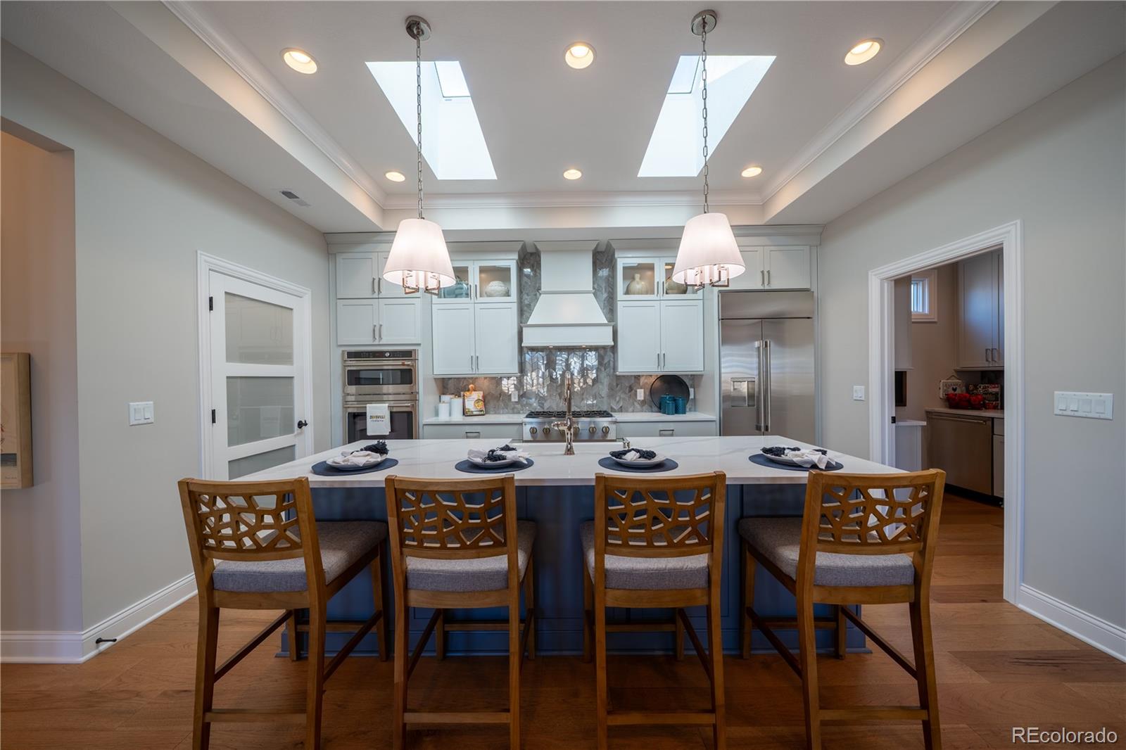 367 Josef Circle Fort Lupton, CO 80621 - Photo 16 of 36 a dining room with a wooden table and chairs
