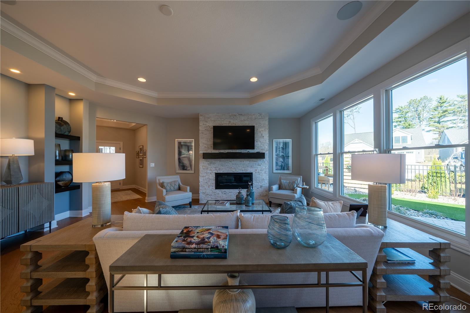 367 Josef Circle Fort Lupton, CO 80621 - Photo 18 of 36 a living room with fireplace furniture and a wooden floor