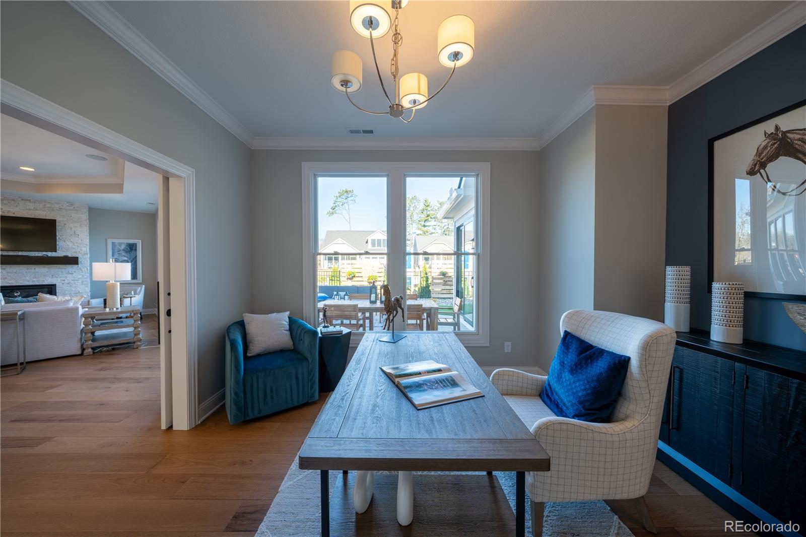 367 Josef Circle Fort Lupton, CO 80621 - Photo 21 of 36 a view of a dining room with furniture a chandelier and wooden floor