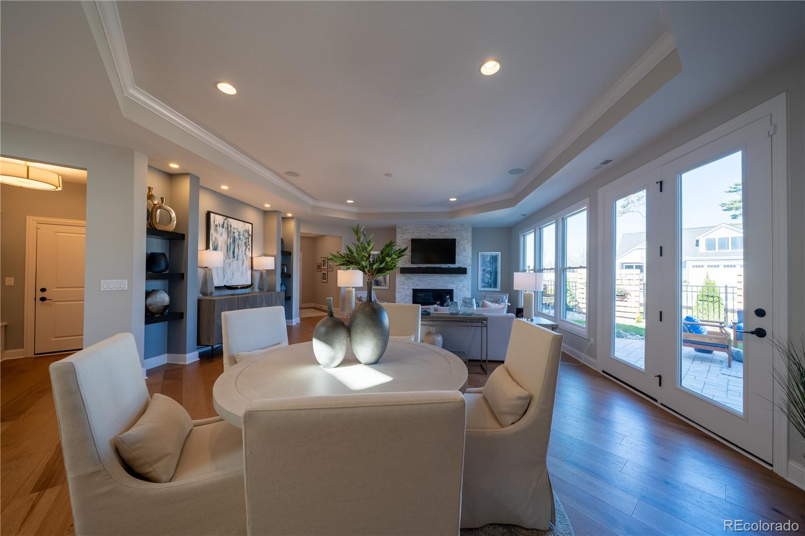 367 Josef Circle Fort Lupton, CO 80621 - Photo 23 of 36 a dining room with furniture a large window and wooden floor