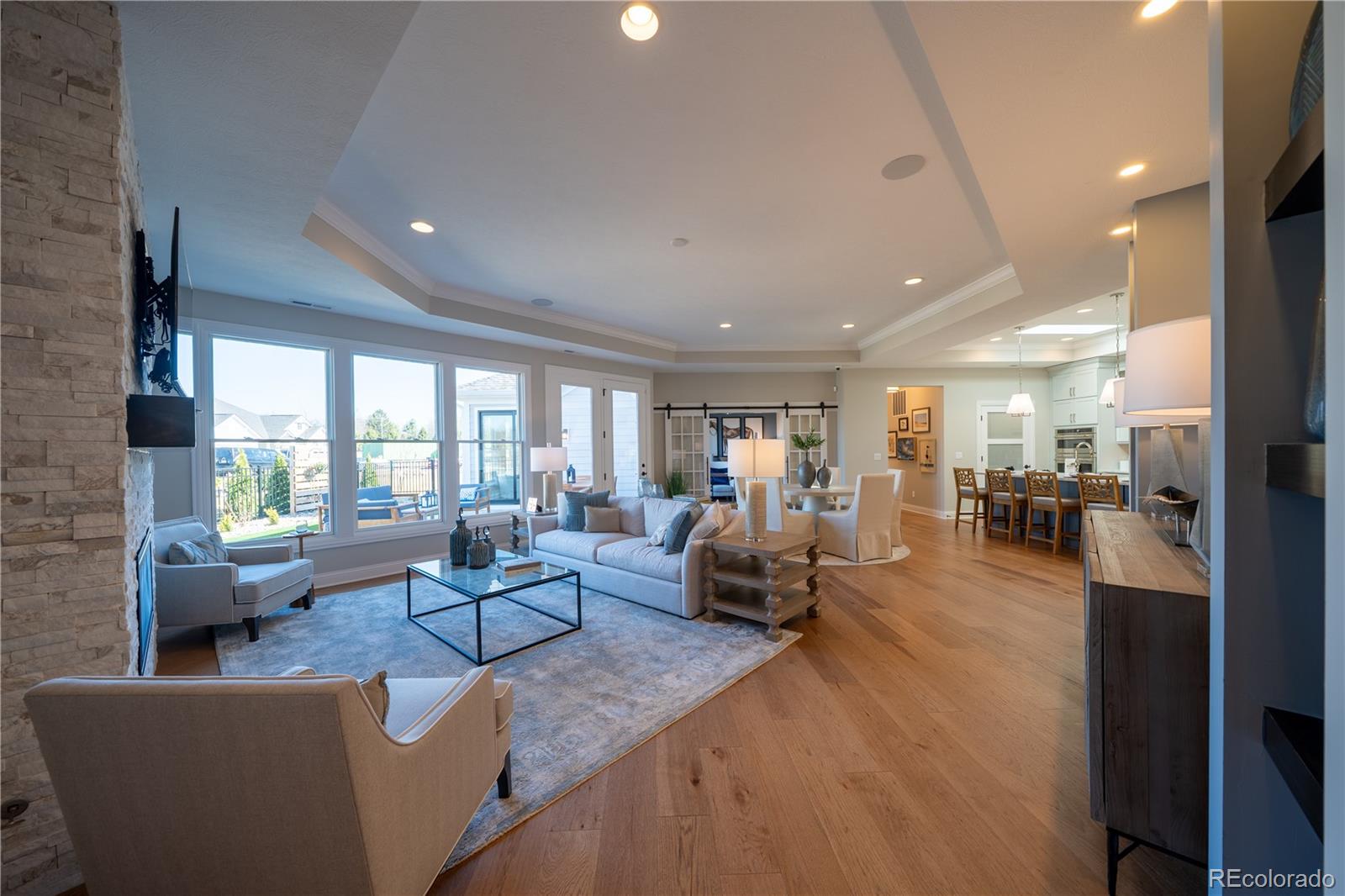 367 Josef Circle Fort Lupton, CO 80621 - Photo 24 of 36 a living room with fireplace furniture and a large window