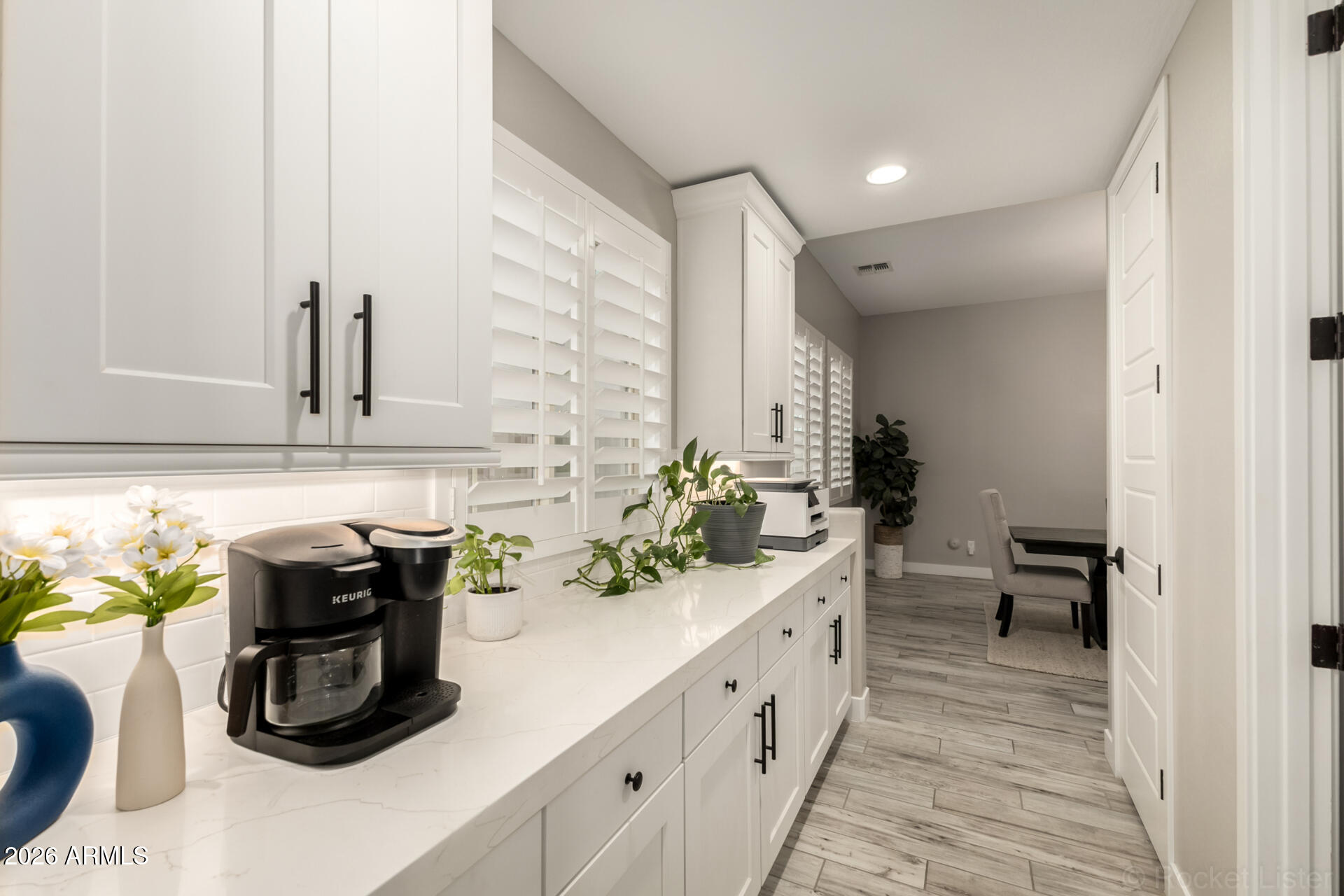 2285 East Athena Avenue Gilbert, AZ 85297 - Photo 12 of 58 a kitchen with stainless steel appliances a sink and a wooden floor