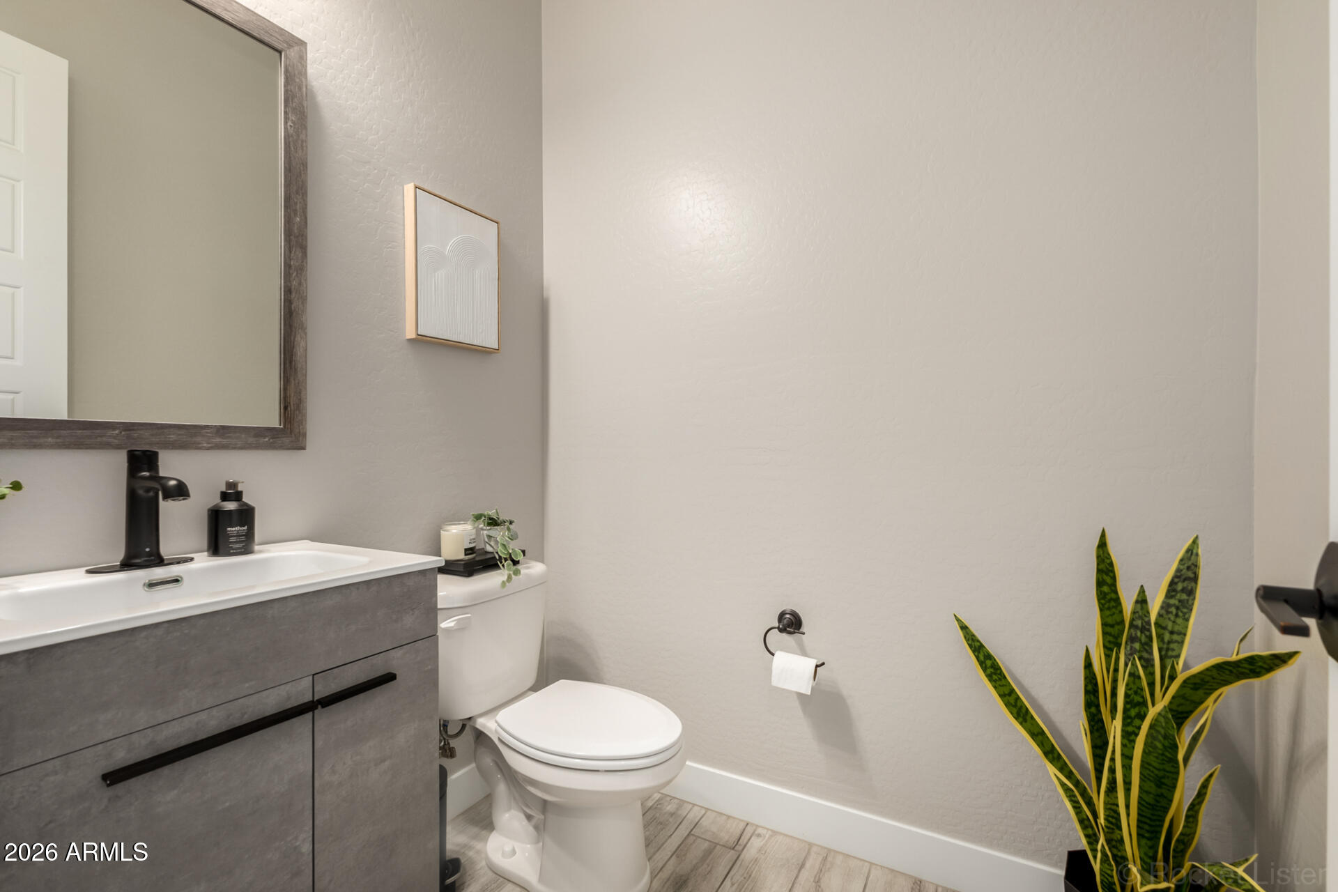 2285 East Athena Avenue Gilbert, AZ 85297 - Photo 16 of 58 a bathroom with a toilet a sink and a mirror