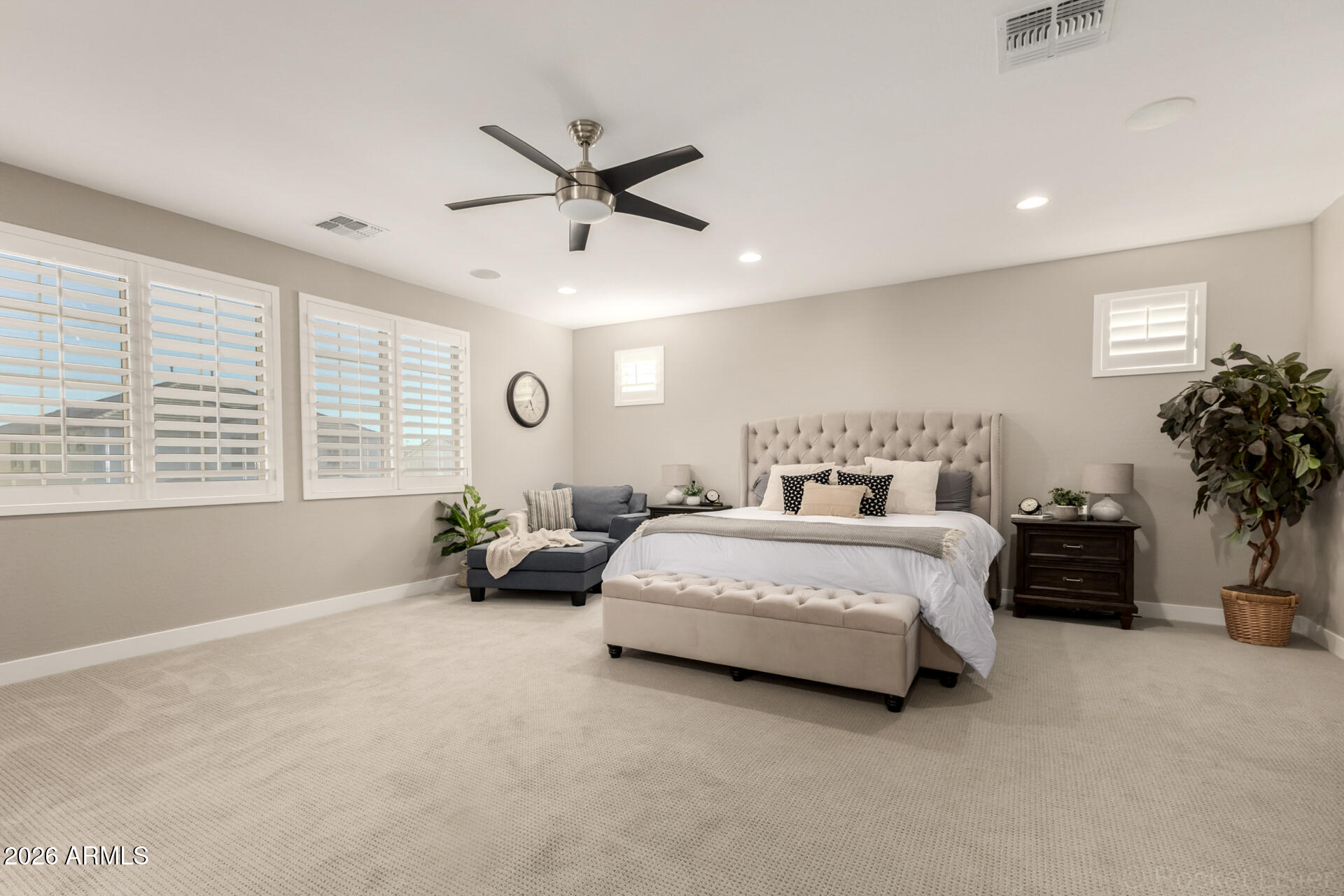 2285 East Athena Avenue Gilbert, AZ 85297 - Photo 22 of 58 a spacious bedroom with a bed a chandelier and a window