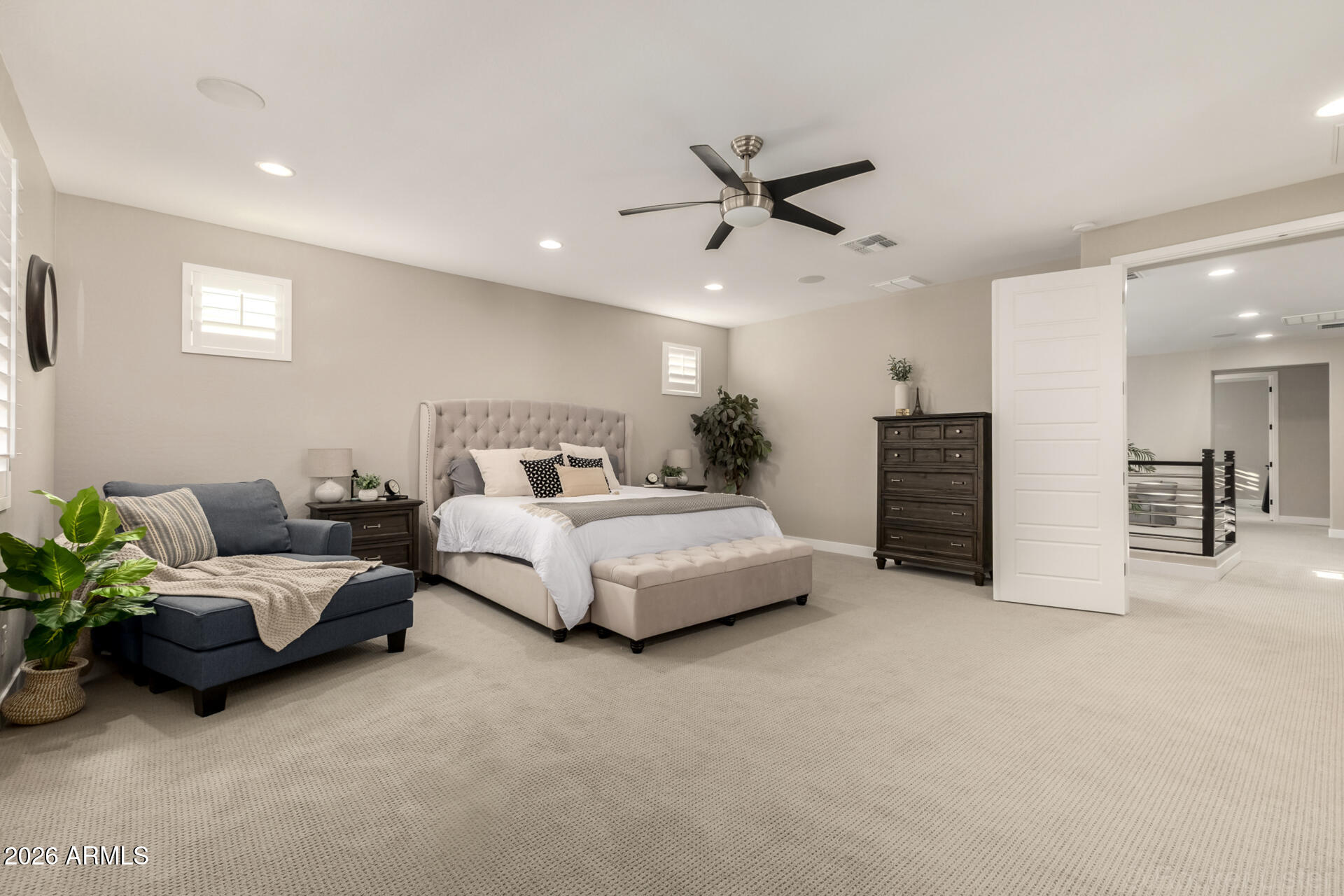 2285 East Athena Avenue Gilbert, AZ 85297 - Photo 23 of 58 a spacious bedroom with a bed and a couch