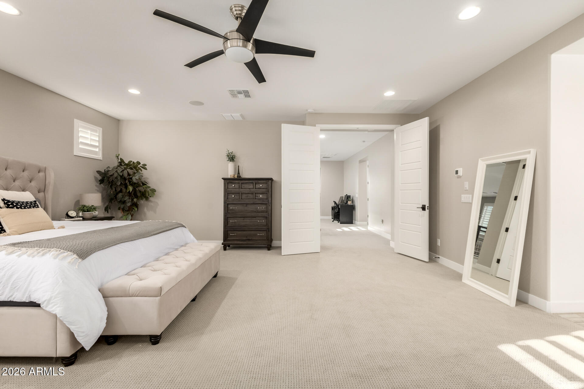 2285 East Athena Avenue Gilbert, AZ 85297 - Photo 24 of 58 a spacious bedroom with a bed and ceiling fan
