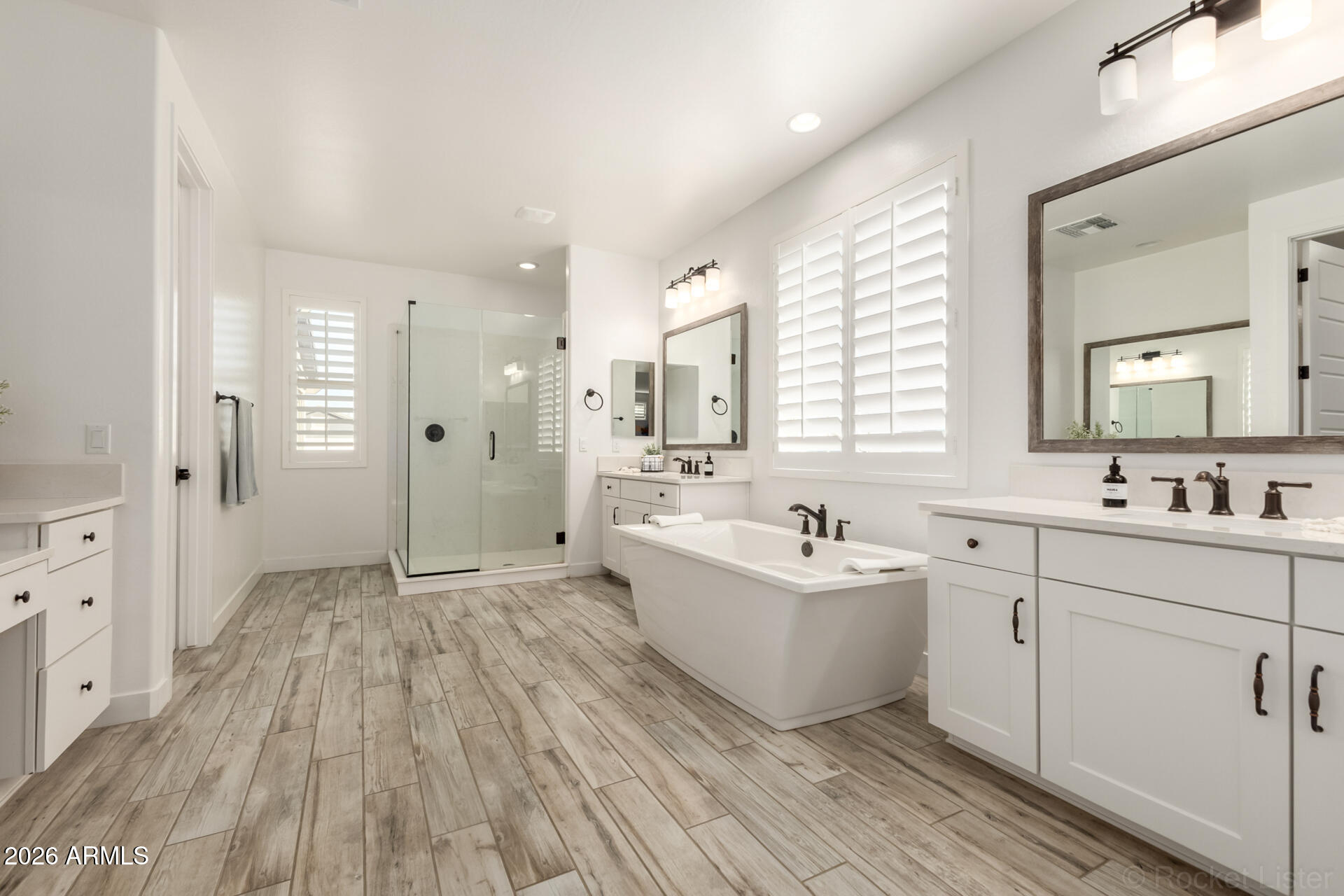 2285 East Athena Avenue Gilbert, AZ 85297 - Photo 25 of 58 a spacious bathroom with a double vanity sink a mirror and a bathtub