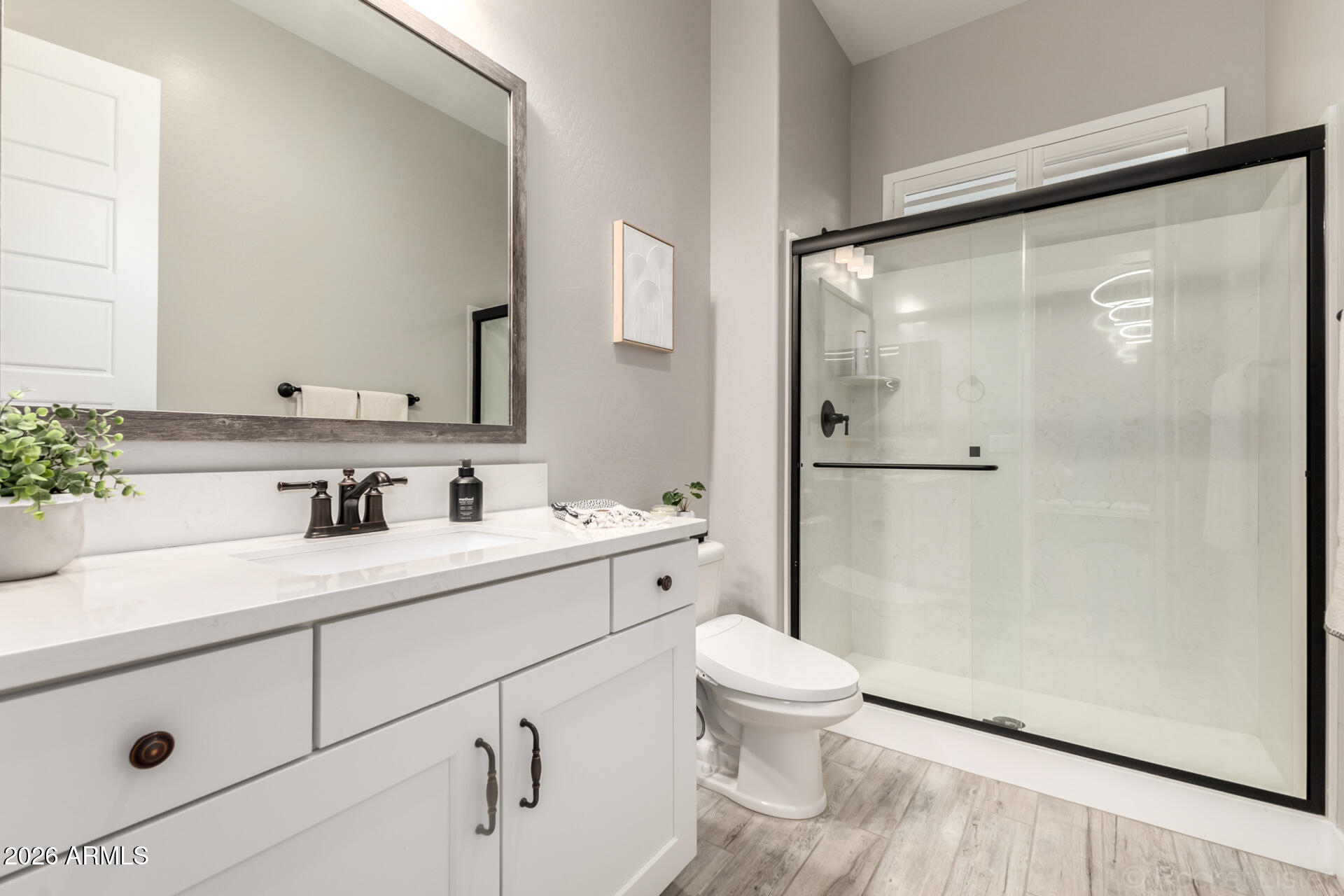 2285 East Athena Avenue Gilbert, AZ 85297 - Photo 29 of 58 a bathroom with a granite countertop sink mirror vanity and toilet