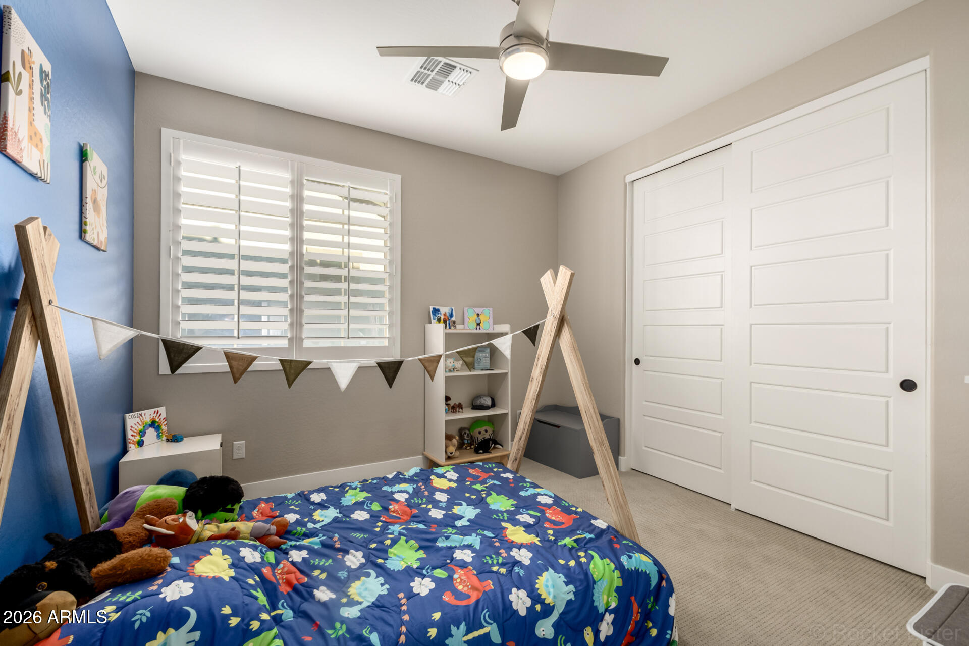 2285 East Athena Avenue Gilbert, AZ 85297 - Photo 30 of 58 a bedroom with a bed and a chandelier
