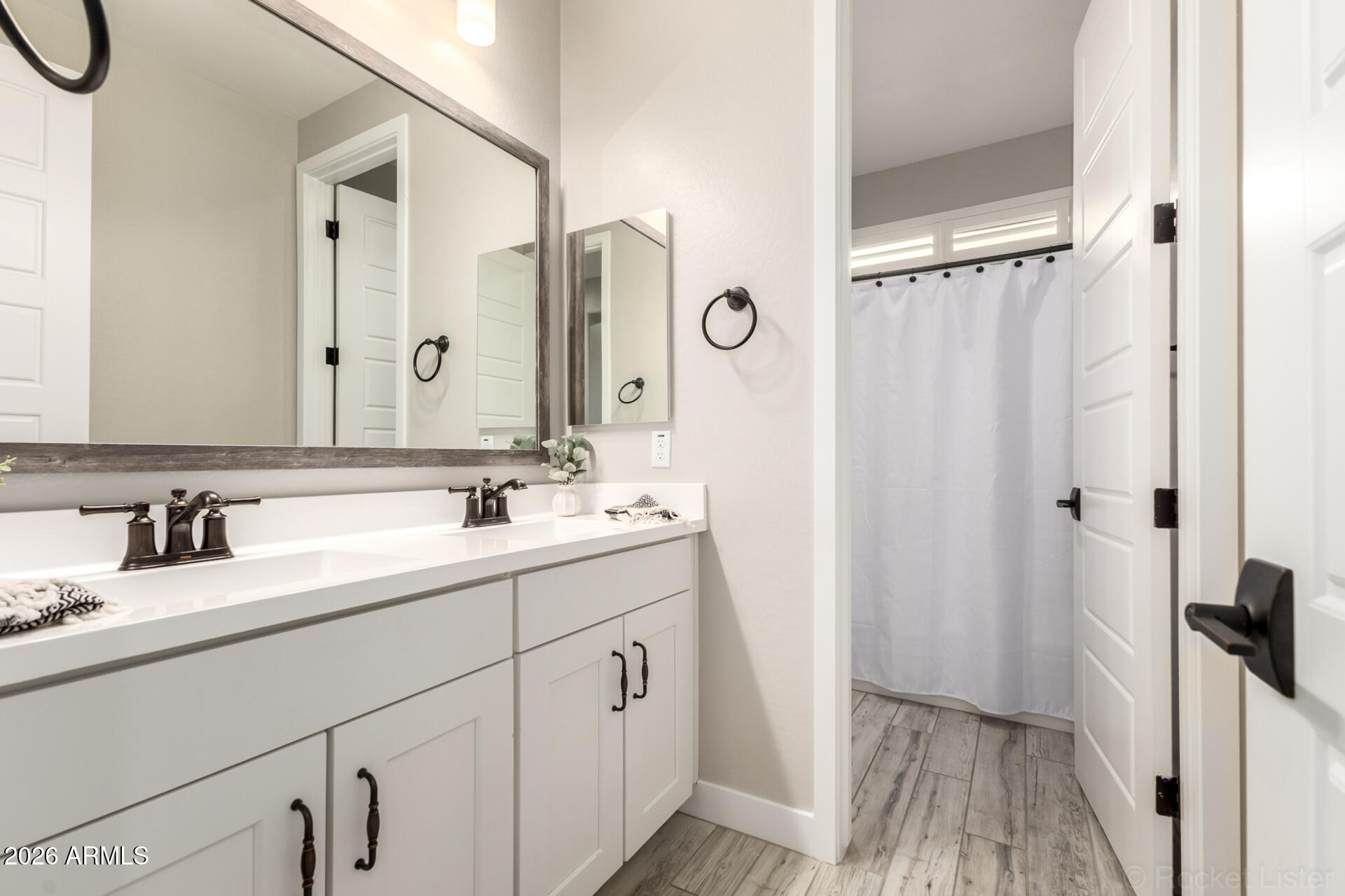 2285 East Athena Avenue Gilbert, AZ 85297 - Photo 31 of 58 a bathroom with a double vanity sink a mirror a vanity and a shower