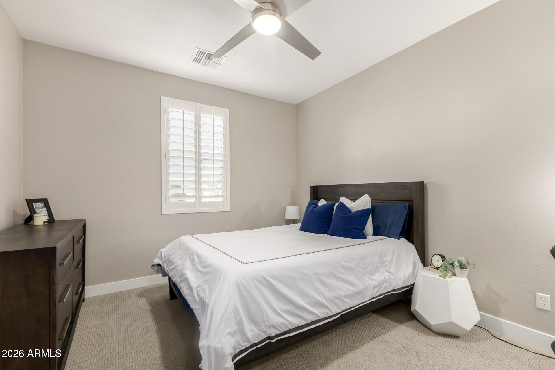 2285 East Athena Avenue Gilbert, AZ 85297 - Photo 33 of 58 a bedroom with a bed and a chandelier