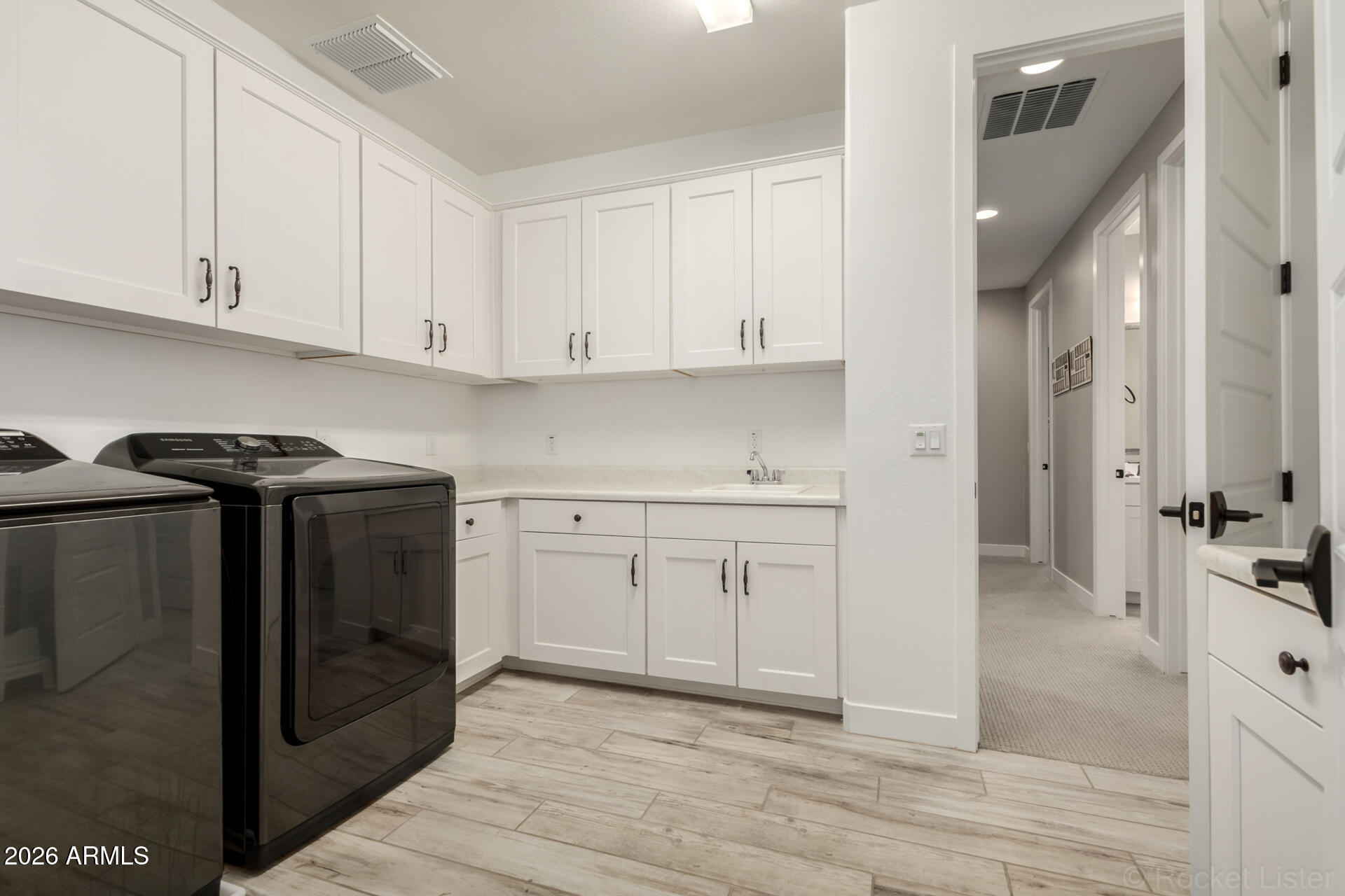 2285 East Athena Avenue Gilbert, AZ 85297 - Photo 37 of 58 a kitchen with white cabinets and sink