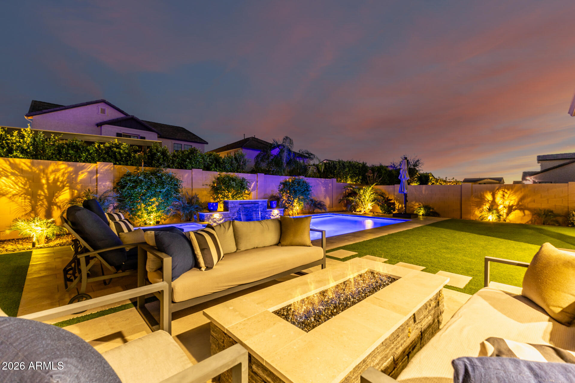 2285 East Athena Avenue Gilbert, AZ 85297 - Photo 43 of 58 a view of a patio with couches table and chairs under an umbrella