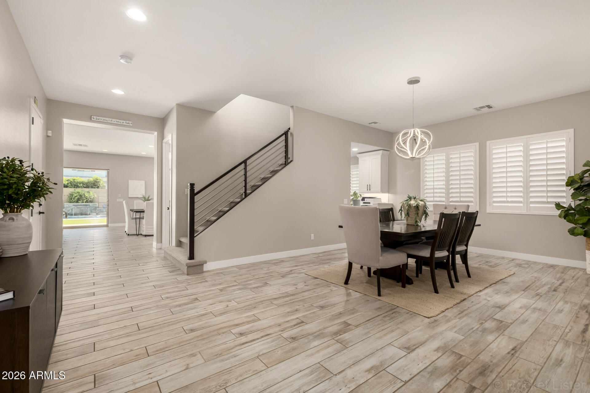 2285 East Athena Avenue Gilbert, AZ 85297 - Photo 6 of 58 a view of a dining room with furniture and wooden floor