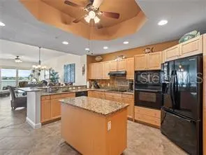 a kitchen with stainless steel appliances granite countertop a sink a stove and a refrigerator