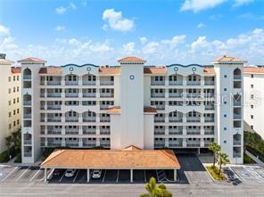 17735 Gulf Boulevard, Unit 204 Redington Shores, FL 33708 - Photo 22 of 23 a view of a building with a yard