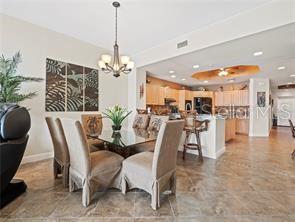 17735 Gulf Boulevard, Unit 204 Redington Shores, FL 33708 - Photo 6 of 23 a view of a dining room and livingroom with furniture a chandelier and kitchen view