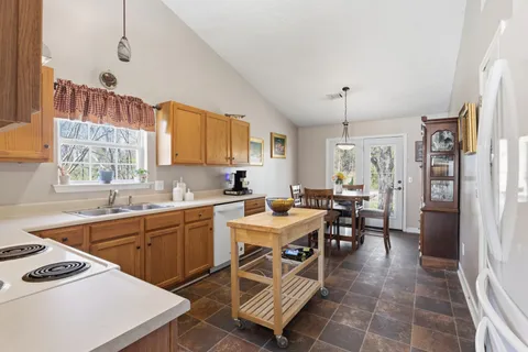 a kitchen that has a sink counter and chairs