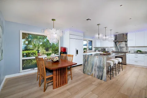 a view of a dining room with furniture and chandelier
