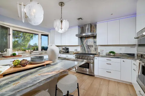 a large kitchen with cabinets and stainless steel appliances