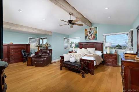 a spacious bedroom with a large bed and a large window
