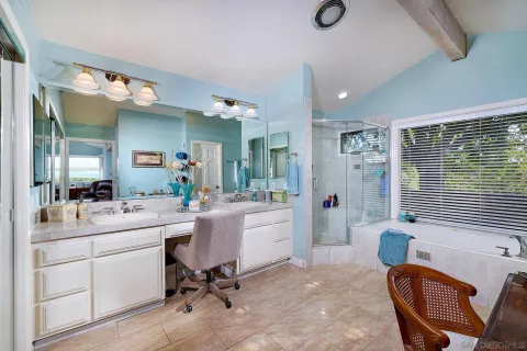 a en suite bathroom with double sink and a mirror