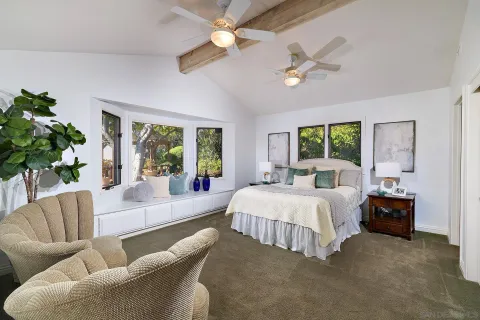 a bedroom with a bed and a large window