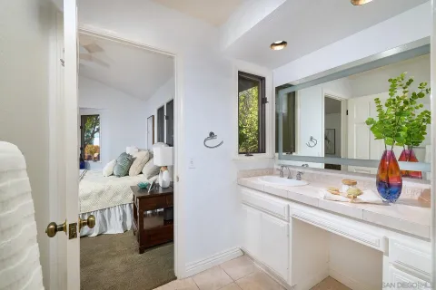 a kitchen with stainless steel appliances granite countertop a sink a stove white cabinets a dining table and chairs