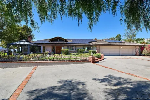 a view of a house with swimming pool and sitting area