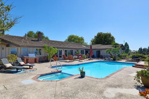 a view of a swimming pool and lounge chairs