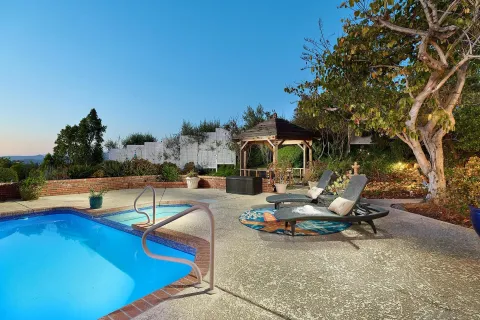 a view of a chairs and table in patio