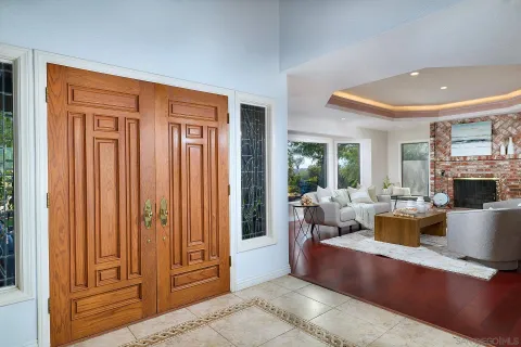 a living room with fireplace furniture and a large window