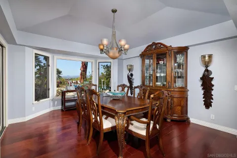 a living room with furniture a fireplace and a chandelier