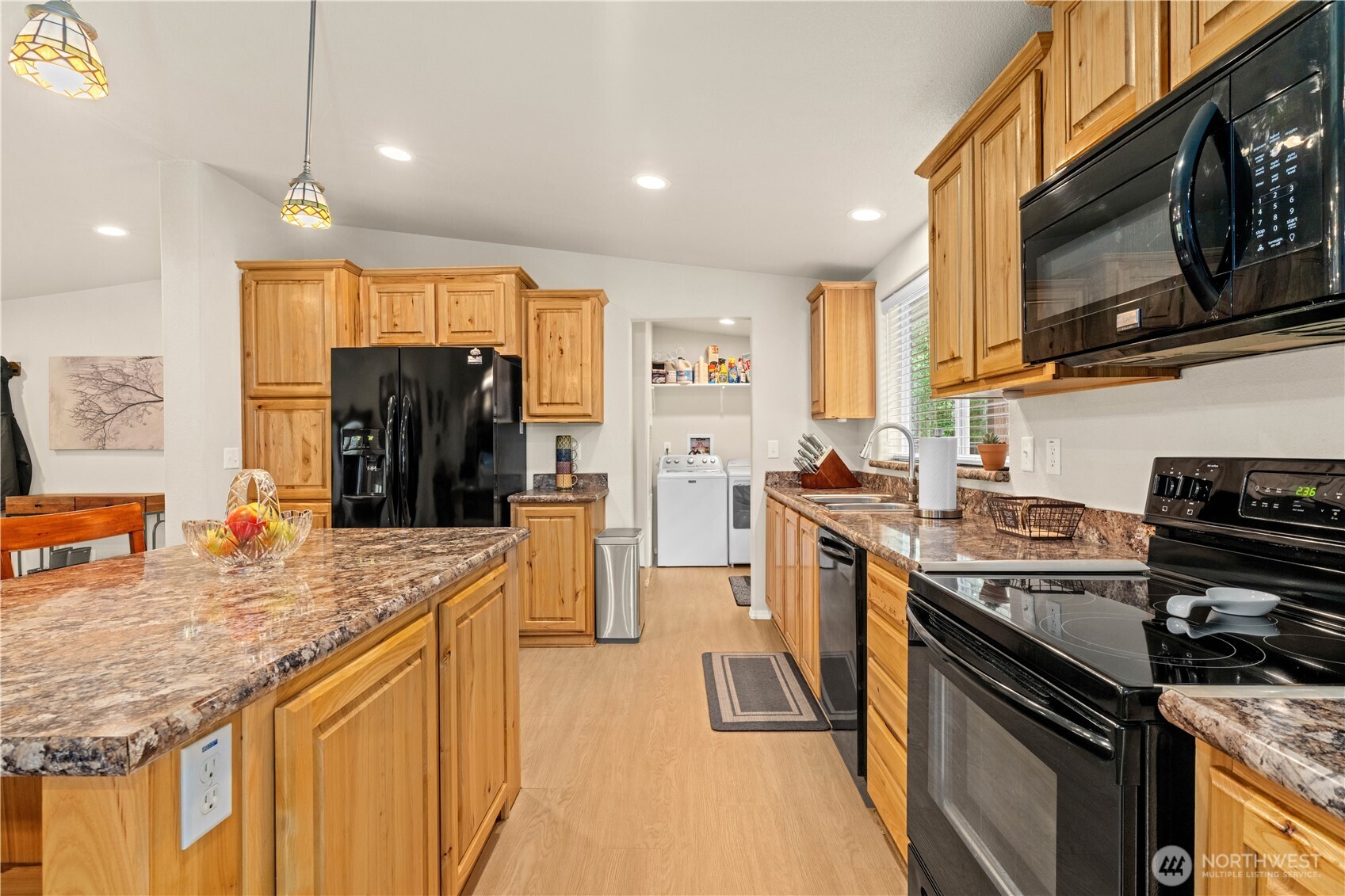 132 River Park Road Forks, WA 98331 - Photo 10 of 40 a kitchen with stainless steel appliances granite countertop a stove a sink and a microwave