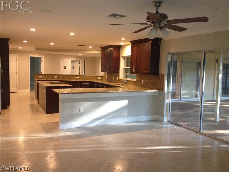 17721 Frank Road Alva, FL 33920 - Photo 4 of 19 a view of a kitchen with stainless steel appliances granite countertop a stove and a refrigerator
