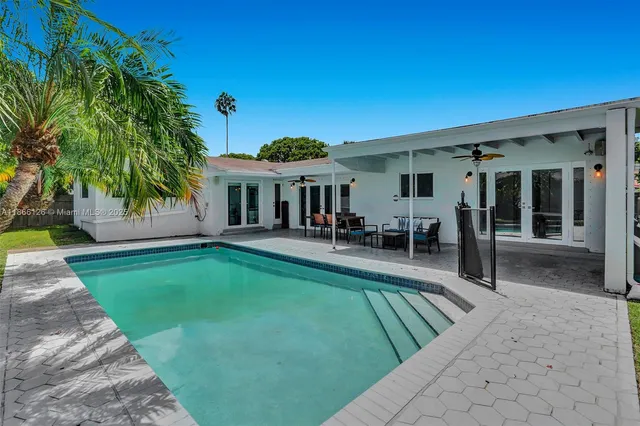 a view of a house with swimming pool and porch