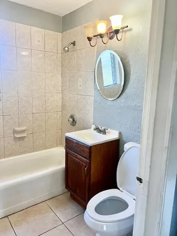 a bathroom with a toilet a sink and bathtub