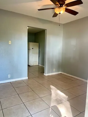 a view of an empty room with a ceiling fan