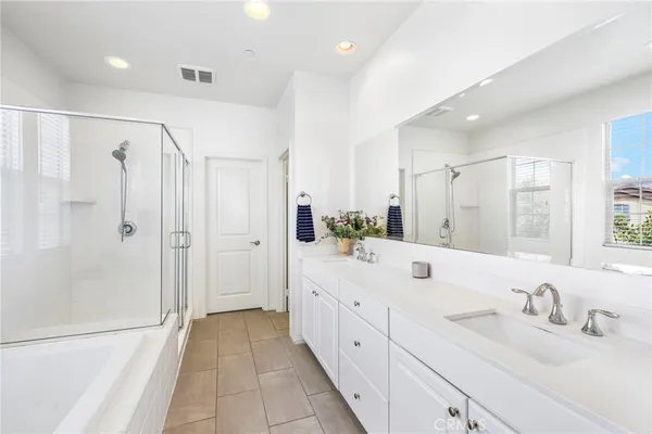 a bathroom with a double vanity sink mirror double and shower