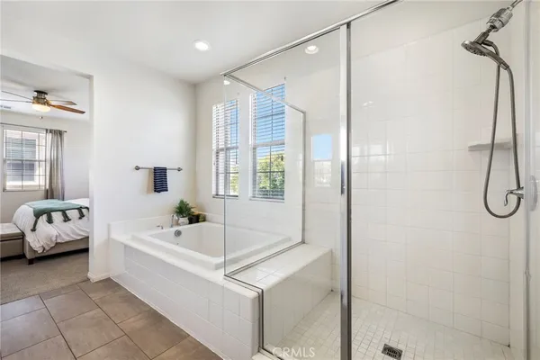 a en suite bathroom with a tub shower and window