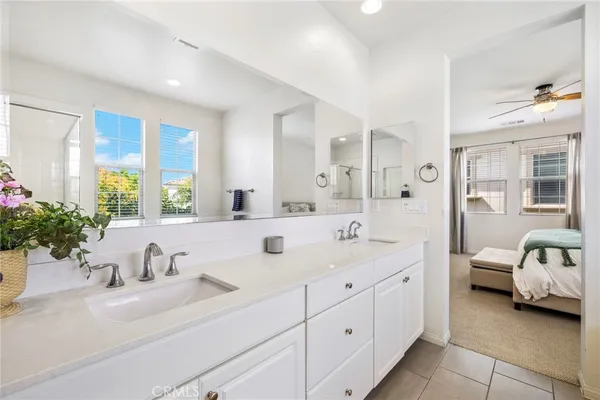 a en suite bathroom with double sink and a mirror