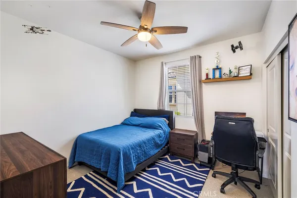a bedroom with a bed and a desk