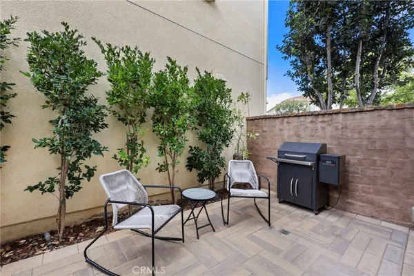 a backyard of a house with table and chairs